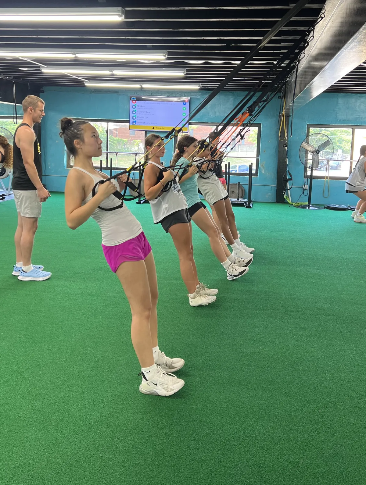 12U & 14U Softball athletes training on TRX straps at RAF